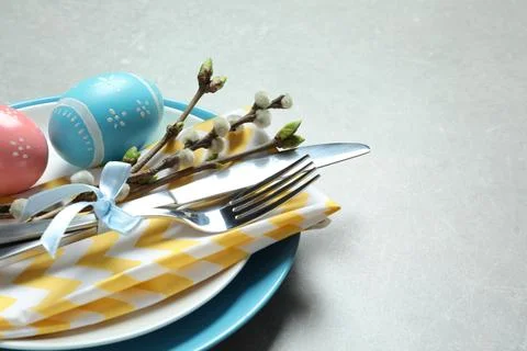 Festive Easter table setting with painted eggs on color background, closeup.  Stock Photos