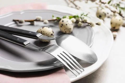 Festive Easter table setting with quail eggs on color background, closeup Foto stock
