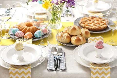 Festive Easter table setting with traditional meal Stock Photos