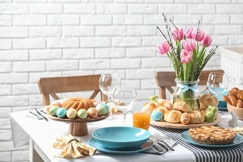 Festive Easter table setting with traditional meal at home Stock Photos