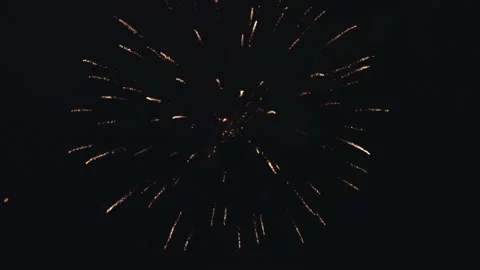 A festive fairfire flies and explodes in the air against the black background of Stock Footage 220321164
