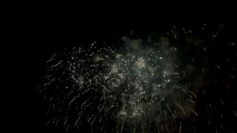 Festive fireworks exploding with bright lights in the night sky over the cit Stockbeeldmateriaal 347517980