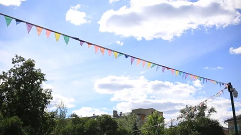 Festive flags on the background of the blue sky and trees Stock Footage 112594573