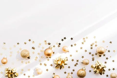 Festive flat-lay arrangement featuring golden Christmas ornaments, glittery.. Stock Photos