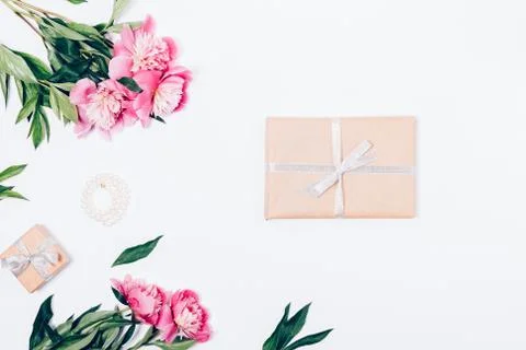 Festive flat lay composition with peonies, pearls and presents Stock Photos
