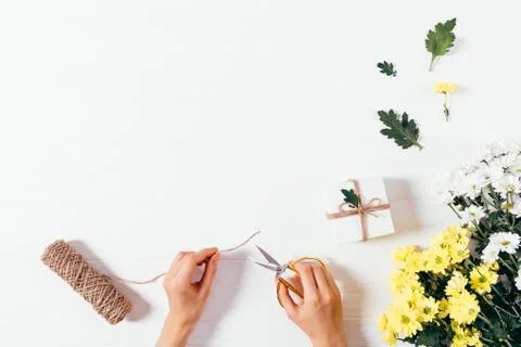 Festive flat layout woman's hands holding scissors Stock Photos