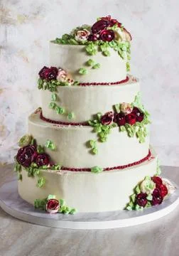 Festive four-level white elegant cake with cream flowers, wedding cake, cream Stock Photos