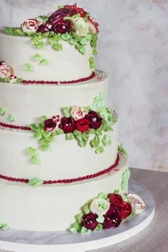 Festive four-level white elegant cake with cream flowers, wedding cake, cream Stock Photos