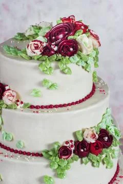 Festive four-level white elegant cake with cream flowers, wedding cake, cream Stock Photos
