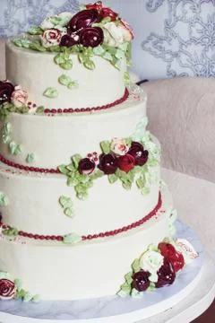 Festive four-level white elegant cake with cream flowers, wedding cake, cream Stock Photos