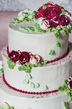 Festive four-level white elegant cake with cream flowers, wedding cake, cream Stock Photos