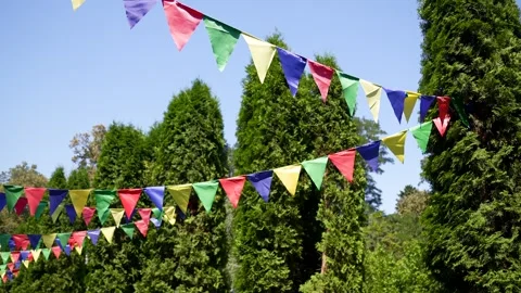 Festive garlands of multi-colored triangular pennants create a cheerful Video stock 314941763