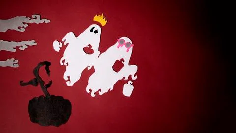 Festive ghosts fly over a black pumpkin among the fog on a red background Stock Photos