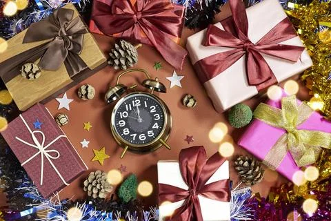Festive Gift Boxes, Clock and Ribbons Create Warm Holiday Celebration Scene With Stock Photos