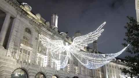 Festive glowing angel lights on Regent Street create an enchanting holiday Stock Footage 299550395