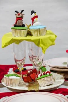 Festive Holiday Cupcakes Table Setting with Champagne Flutes Фото