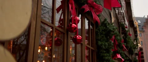 Festive Holiday Decor Featuring Charming Red Bells and Lush Greenery for Stock Footage 313815710