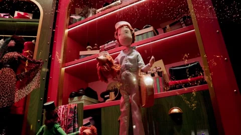 Festive holiday display featuring dolls and vibrant decor in a Paris boutique Stock Footage 295327346
