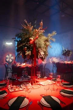 Festive holiday table setting with elegant centerpiece and vibrant red decor Stock Photos