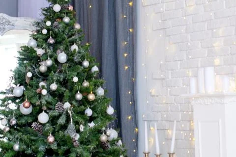 Festive home interior with a beautiful decorated Christmas tree with toys and Stock Photos