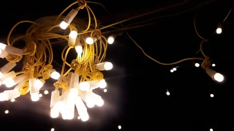 Festive Illuminated String Lights with Glowing Yellow Bulbs and Wiring Stock Footage 311015570