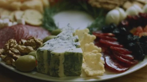 Festive kitchen preparation of placing nuts among the cheese Stock Footage 342139655