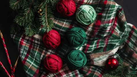 Festive Knitting Setup With Colorful Yarn Balls and Evergreen Branches Stock Footage 294505890