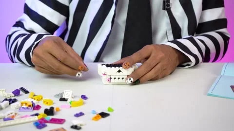 Festive manicure building with interlocking LEGO bricks, close-up Stock Footage 329591156