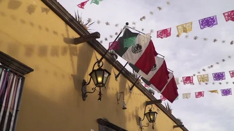 Festive mexican flags walk by shot Stock Footage 84248347