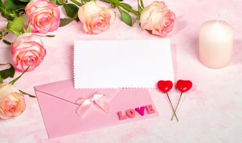 Festive mock up with roses, envelope, empty blank sheet, candle, hearts, le.. Stock Photos