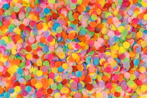 Festive multicolored confetti background. Flat lay style. Stock Photos