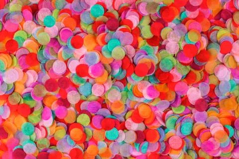Festive multicolored confetti background. Flat lay style. Stock Photos