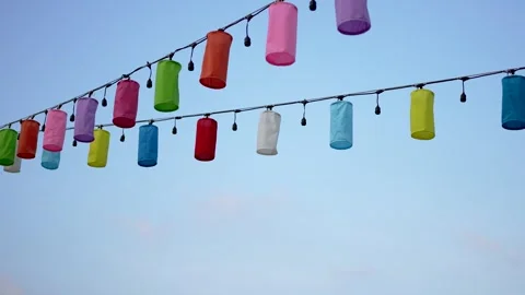 Festive Multicolored Lanterns Dancing in the Blue Sky Stock Footage 264347885