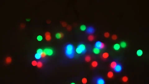 Festive multicolored lights of the garland rhythmically blink at night on a Video stock 166206437