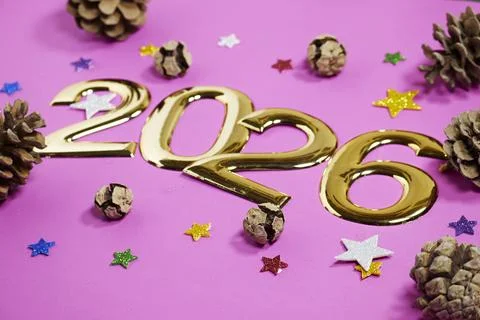 Festive New Year scene featuring shiny gold 2026 numerals surrounded by pinecone Stock Photos