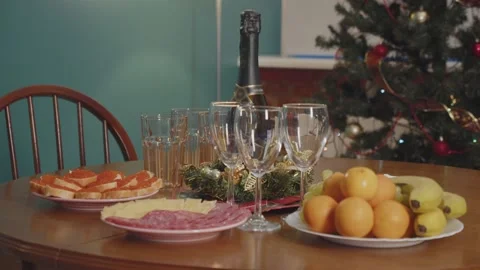 Festive New Year's table with a green Christmas tree in the background 動画素材 169099324