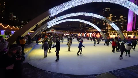 Festive night ice skating crowd at Nathan Phillips Square Toronto Stock Footage 330859507