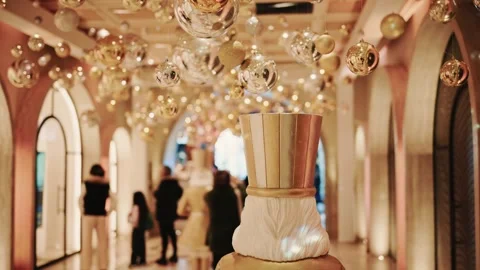 Festive nutcracker figure with glittering ornaments suspended in ornate hal.. Stock Footage 335514548