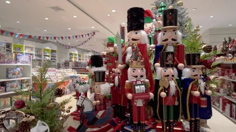 Festive Nutcracker soldiers display in storefront Christmas decor scene. Stock Footage 321042995