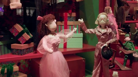 Festive Paris boutique display with elegant dolls in holiday attire surrounded Stock Footage 295565684