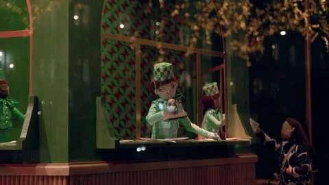 A festive Paris boutique display featuring a whimsical elf figurine in a Stock Footage 295331845