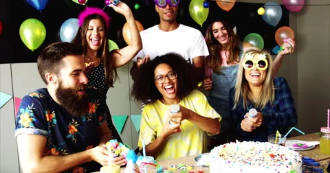 Festive partygoers surrounded by confetti Stock Footage 68205555