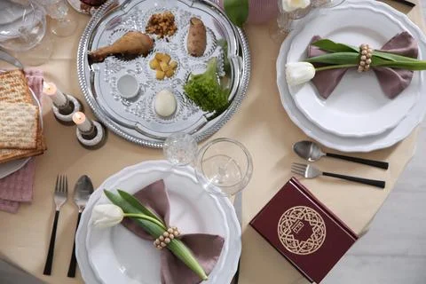 Festive Passover table setting with Torah, top view. Pesach celebration Stock Photos