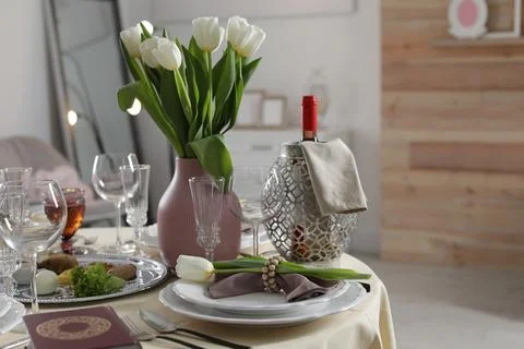 Festive Passover table setting with Torah at home. Pesach celebration Stock Photos