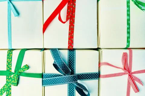 Festive pattern of gift boxes with ribbons. Stock Photos