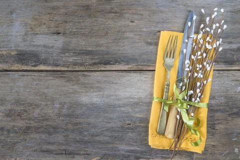 Festive place setting for Easter holiday; Vintage fork, knife, willow twig .. Stock Photos