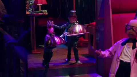 Festive puppet scene with waiters holding trays in a whimsical Paris Christmas Video stock 295565873
