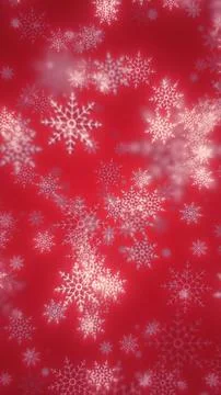 Festive red background with delicate white snowflakes falling in soft focus Stock Photos