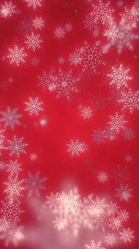 Festive red background with delicate white snowflakes falling in soft focus Stock Photos
