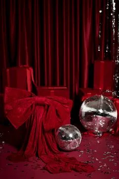 Festive red background with gift boxes, disco balls and sparkling tinsel Stock Photos